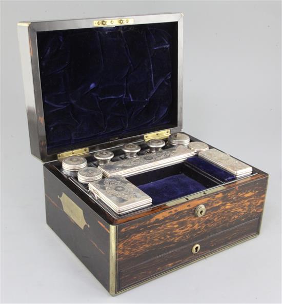 A Victorian brass mounted coromandel wood travelling toilet box containing ten silver mounted bottles/jars, 30.5cm.